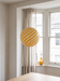 Living room pendant light in a bay window with sheer curtains – the yellow BO-HA Kaja globe.
